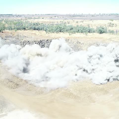 Blast going off in an open pit